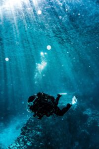 person scuba diving underwater in The Bahamas