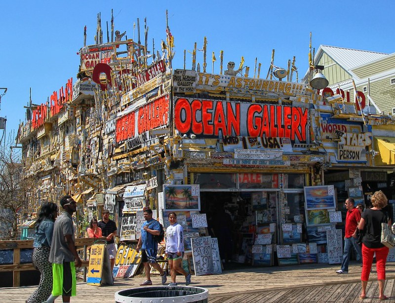 a unqiue store with a logo that says "Ocean Gallery" on a boardwalk in Ocean City 