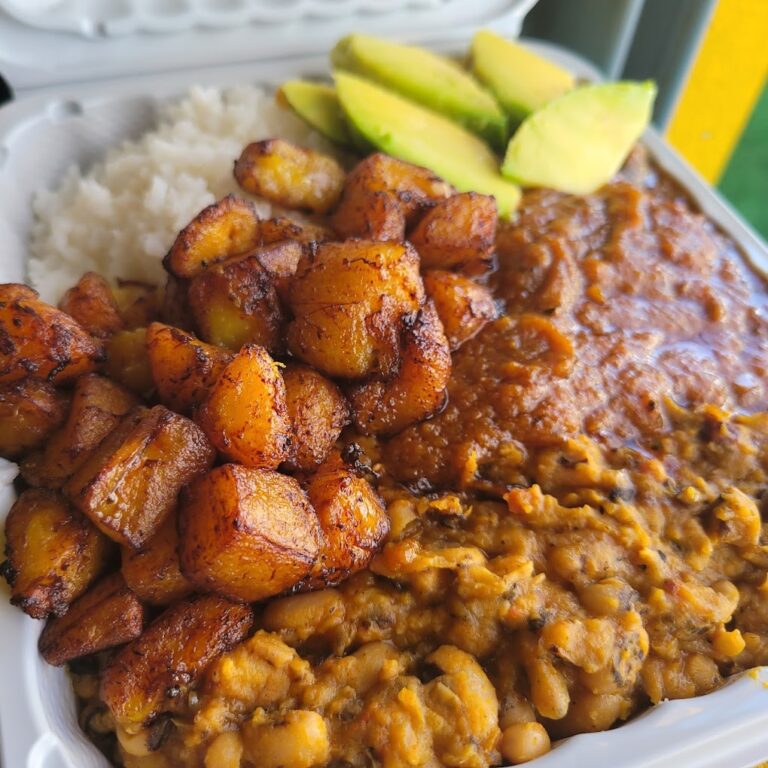 vegan nigerian food including black eyed peas, fried plantain, rice, and avocado.