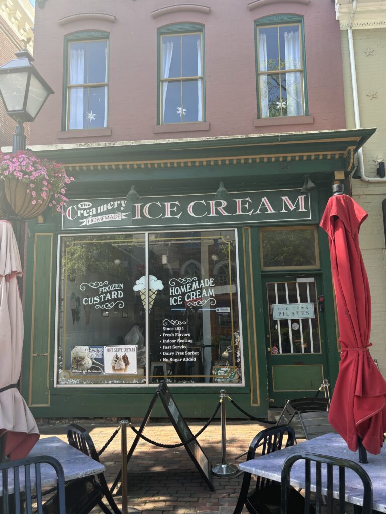 a green vintage building that says, "The Creamery Ice Cream"