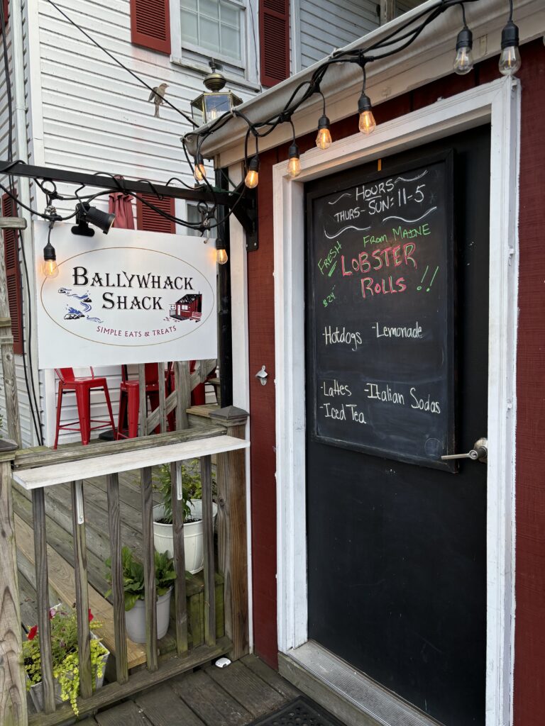 sign says Ballywack Shack with a chalk menu on the right of the sign 