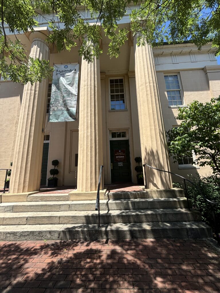 a light pink building with columns named the Lyceum