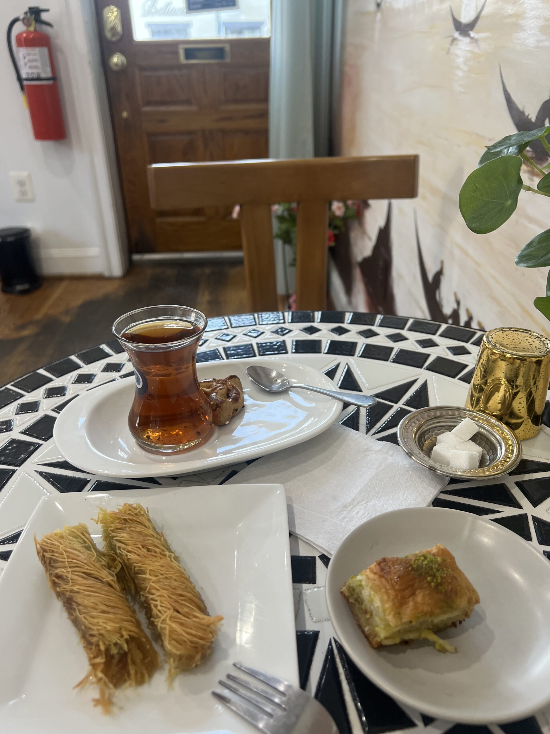 a platter of Turkish desserts including turkish tea, baklava, and other turkish desserts