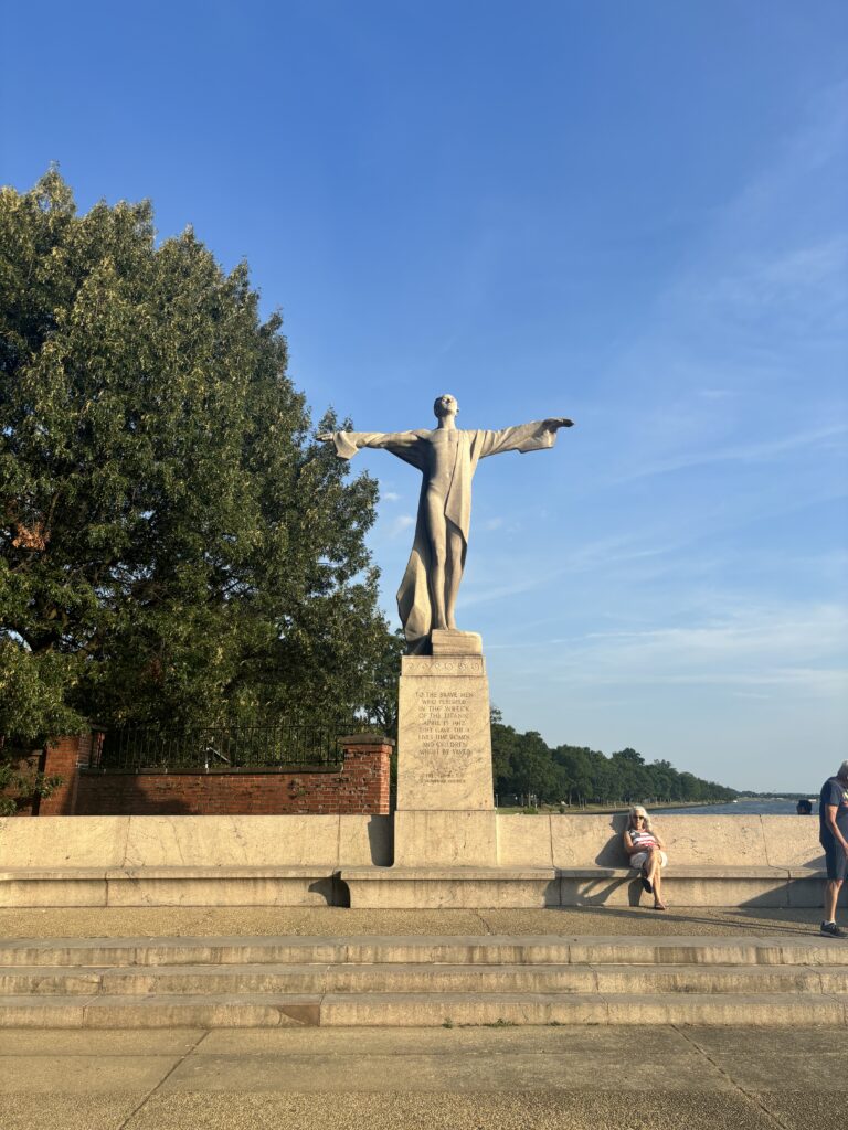 a monument of a man with his arms stretched out. The name of the monument is "Titanic" and its located in Anacostia DC