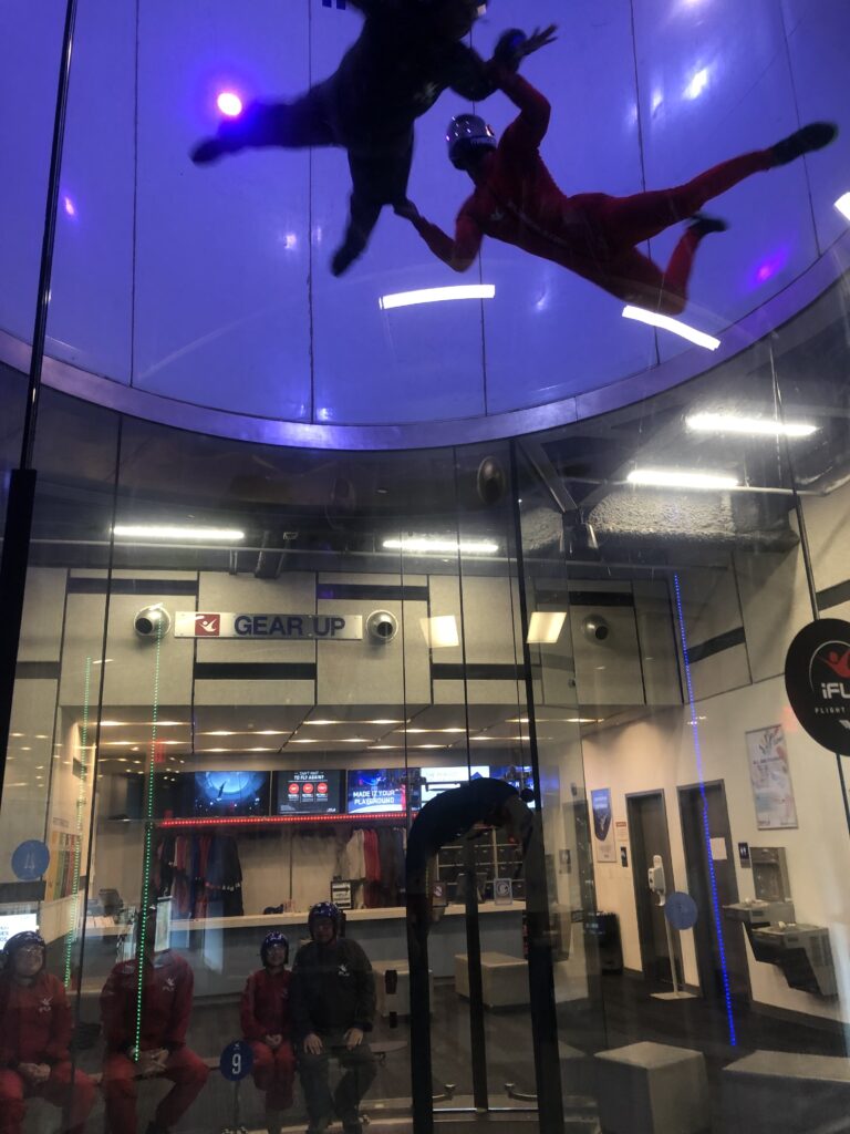 2 people doing indoor skydiving 