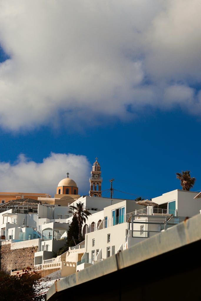 A view of a city with a statue on top of a building in Poros