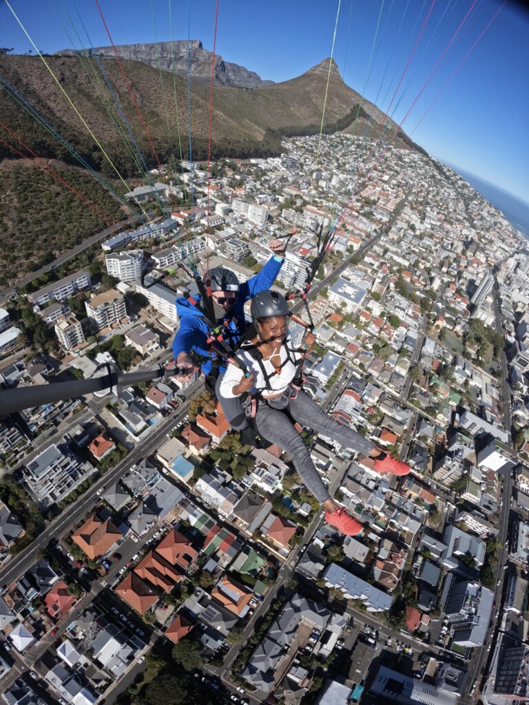 A Black woman paragliding in Cape Town