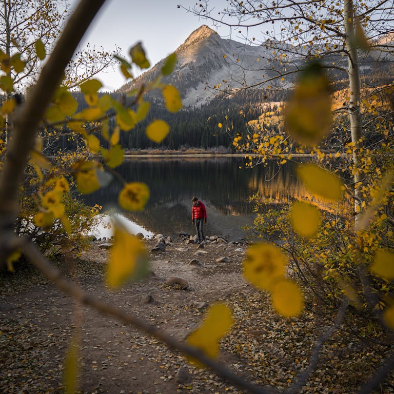 Person in Red Jacket Standing Near the Lake