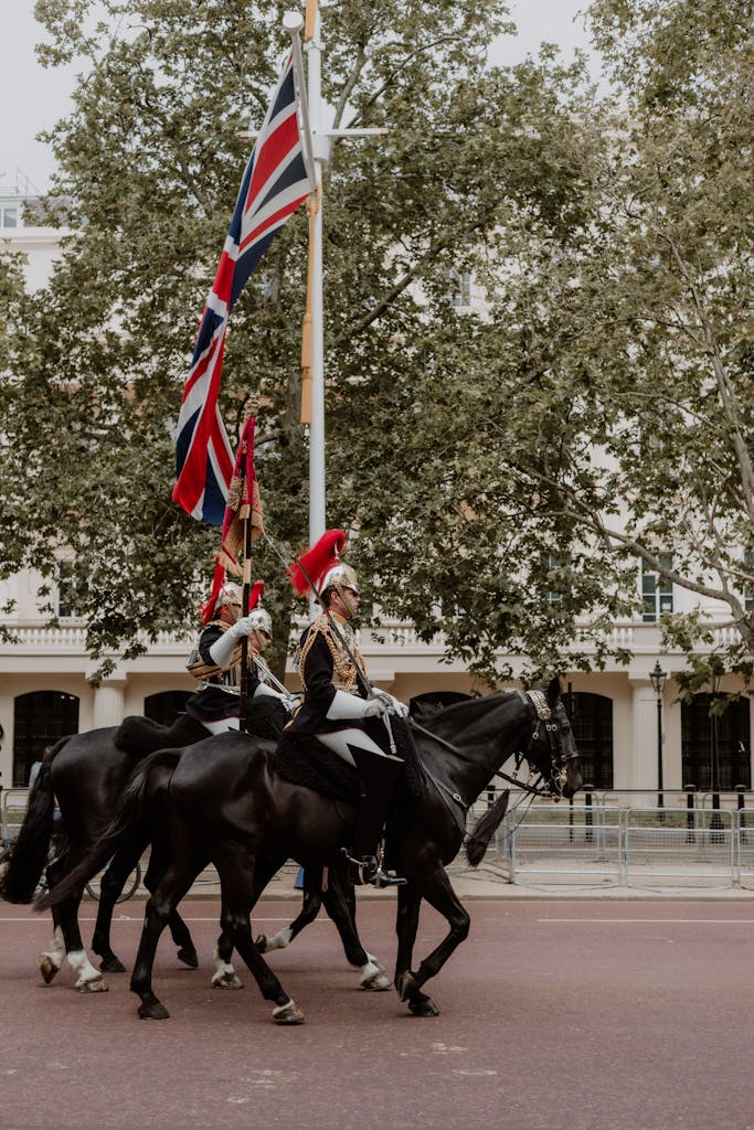 Two men on horses with british flags on their backs