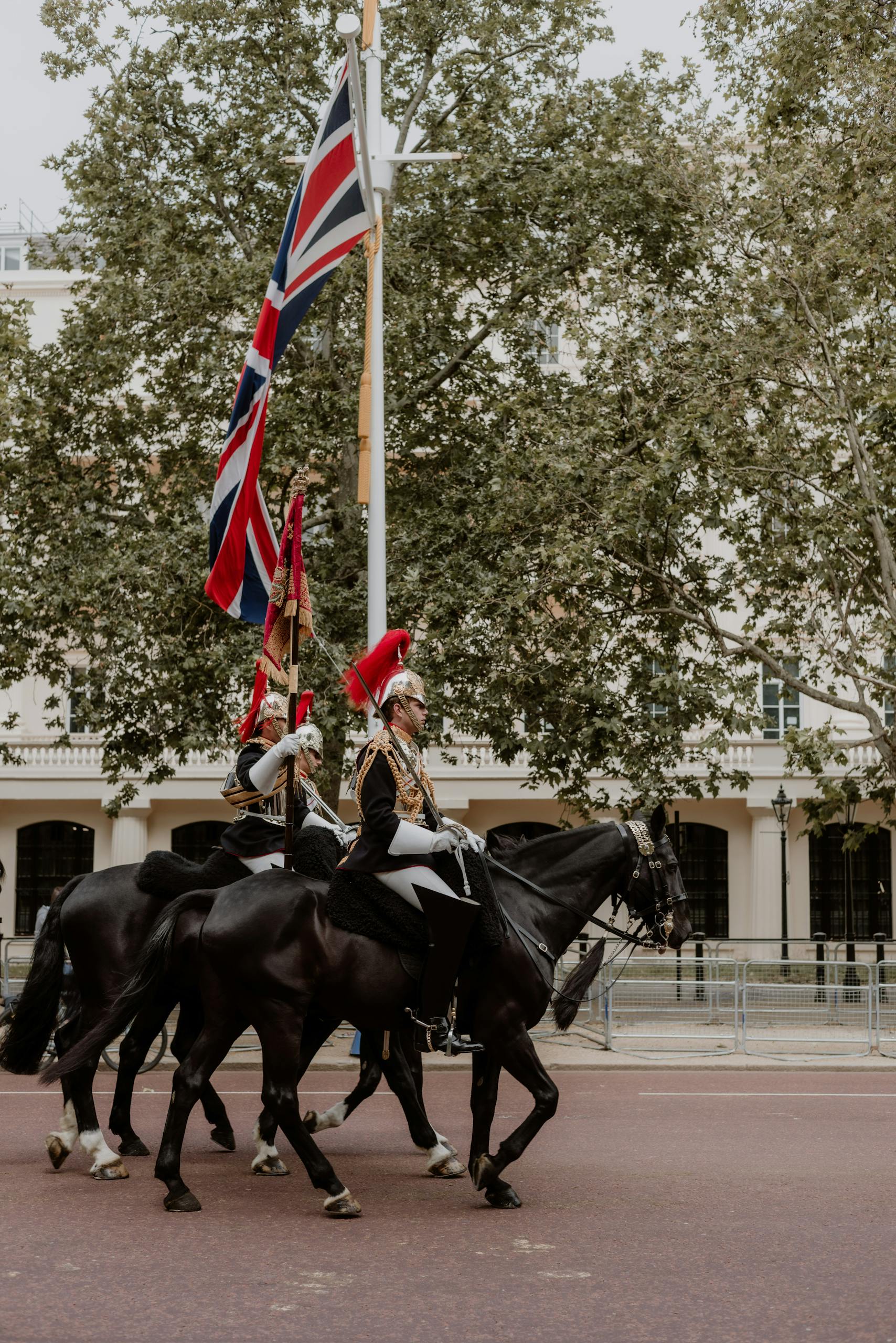 Two men on horses with british flags on their backs