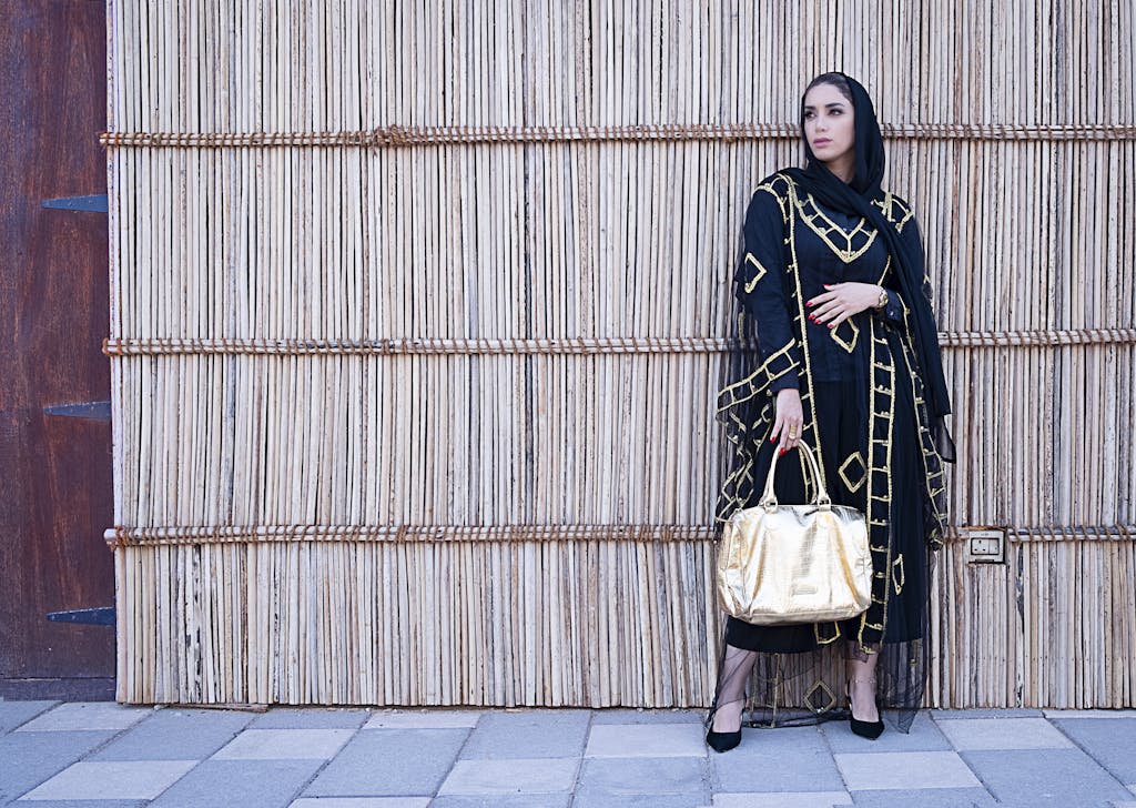 Woman in Blue and Beige Long-sleeved Dress Holding a Yellow Bag