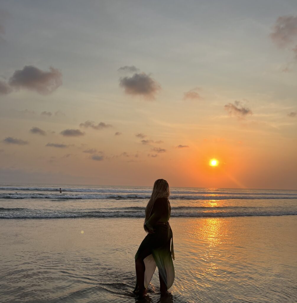 the silohuette of a Black woman on a beach in Kuta or Seminyak