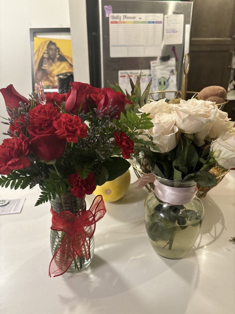 2 sets of flowers in a kitchen