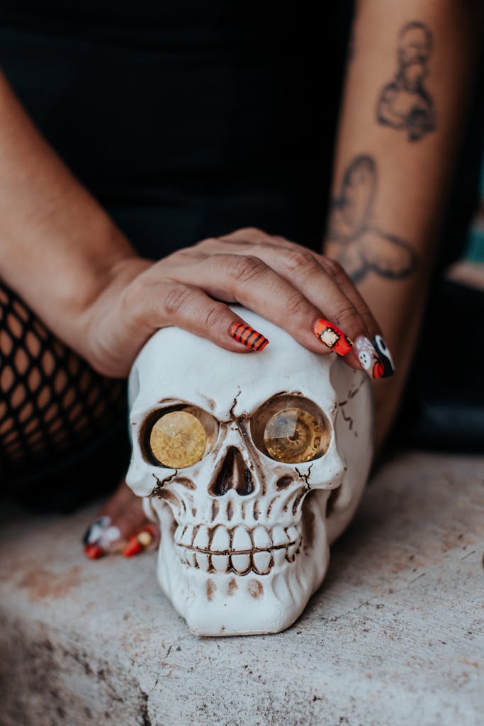 Close-up of Woman Holding a Skull with Halloween inspired nails