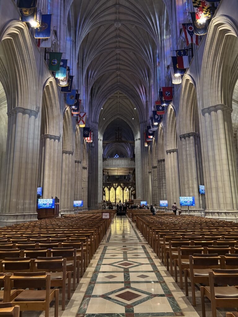 interior of the National Cathedral in DC. There are grand ceiling and lots of arches