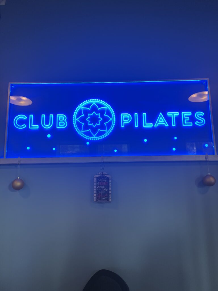 Blue sign that says Club Pilates