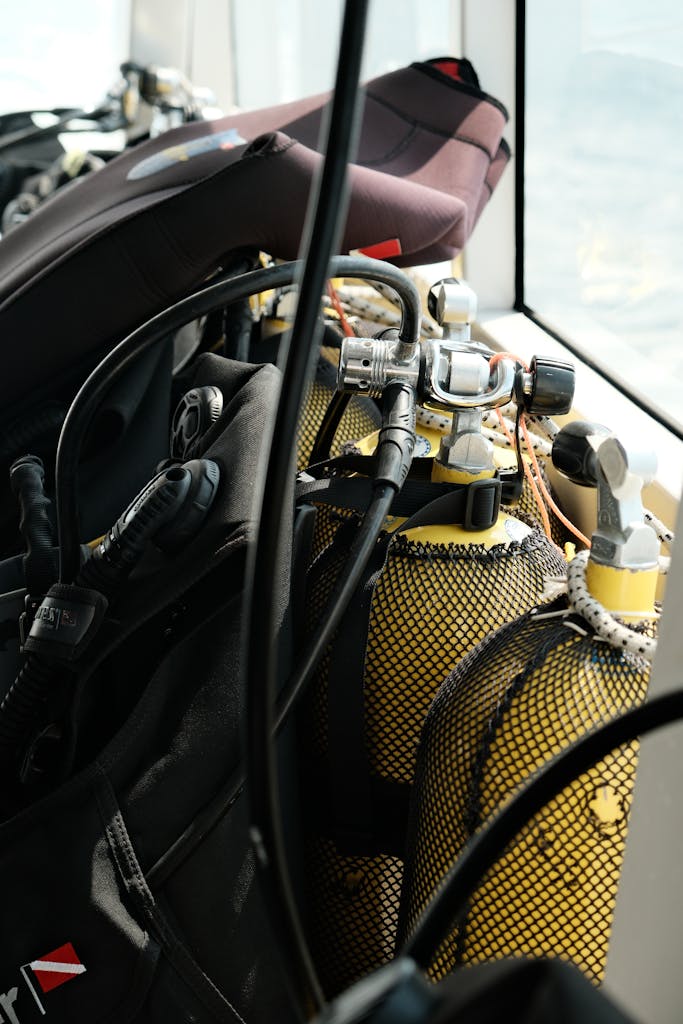 Close-up of scuba diving tanks and gear on a boat ready for underwater exploration.