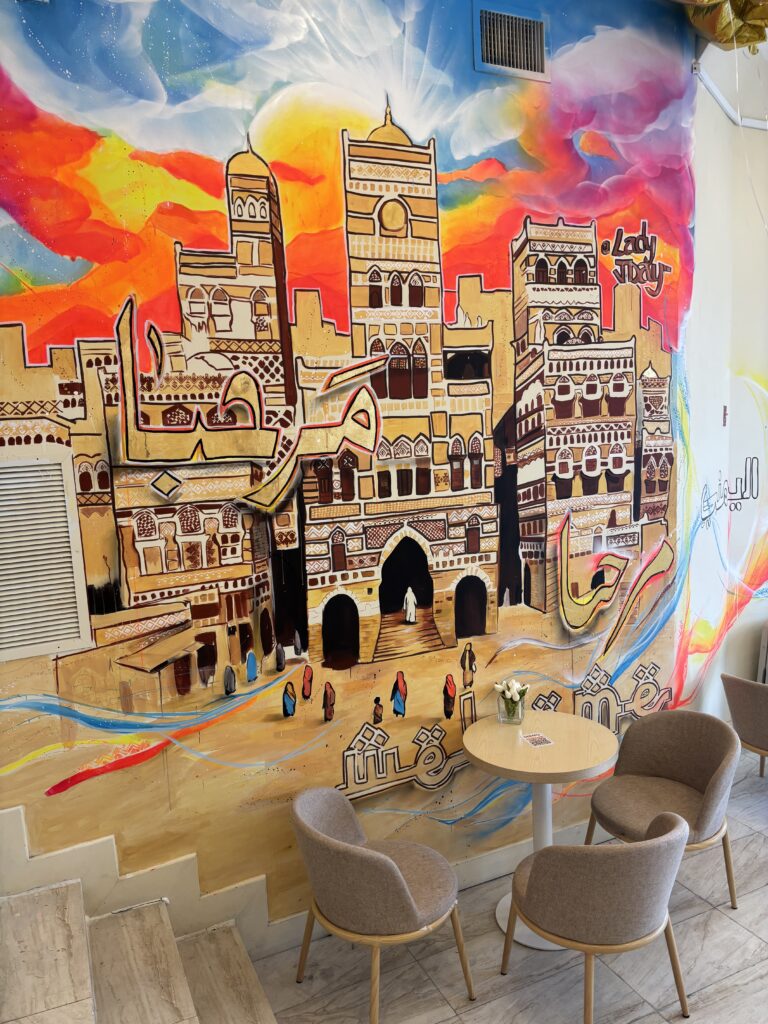 beautiful wall painting of famous Yemeni buildings inside Finjan, an aesthetic coffee shop in the Bronx