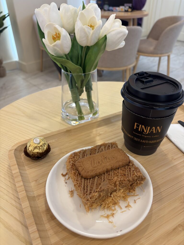 a tray of biscoff knunafeh and coffee inside Finjan, an aesthetic coffee shop in the Bronx