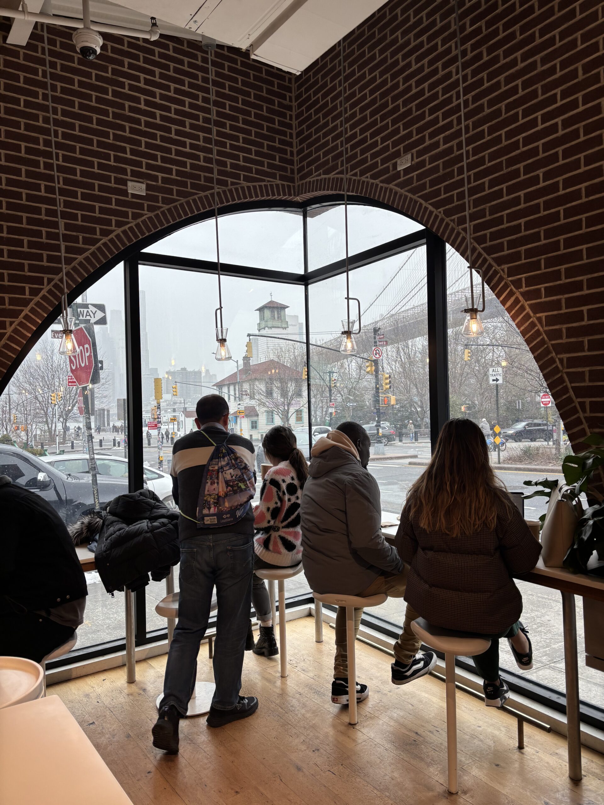 a view of Dumbo Manhattan bridge view from inside Arabica coffee shop