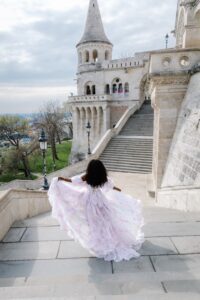 Black woman in princess dress twirling in a light lavender princess dress on the stairs at Fisherman's Bastion